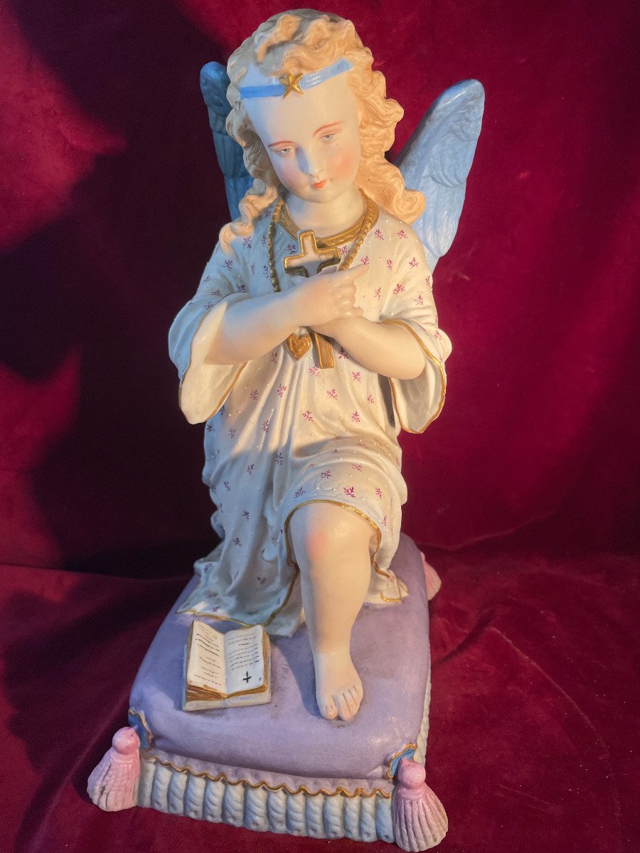 Praying Angel Kneels With A Cross