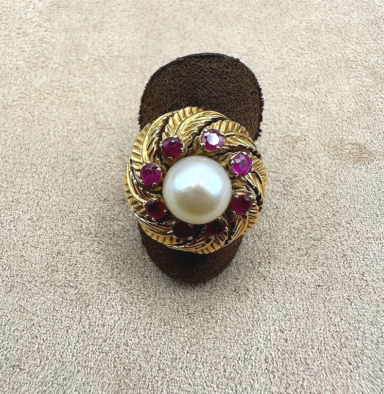 A Yellow Gold Ring Featuring A Cultured Pearl Set In The Center, Surrounded By Treated Rubies.-photo-4