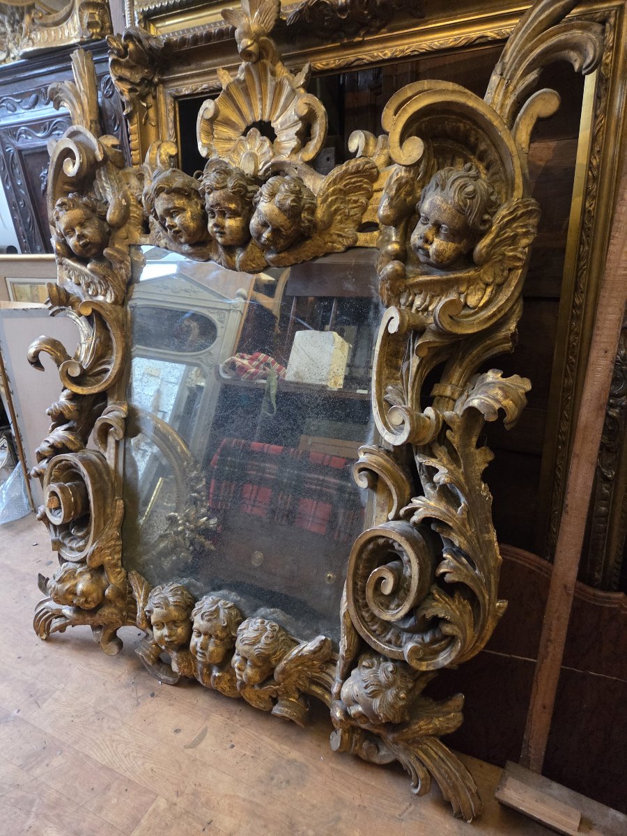 Large Gilded Mirror In The 17th-century Italian Baroque Style, Decorated With Ten Cherub Heads. 160 X 126