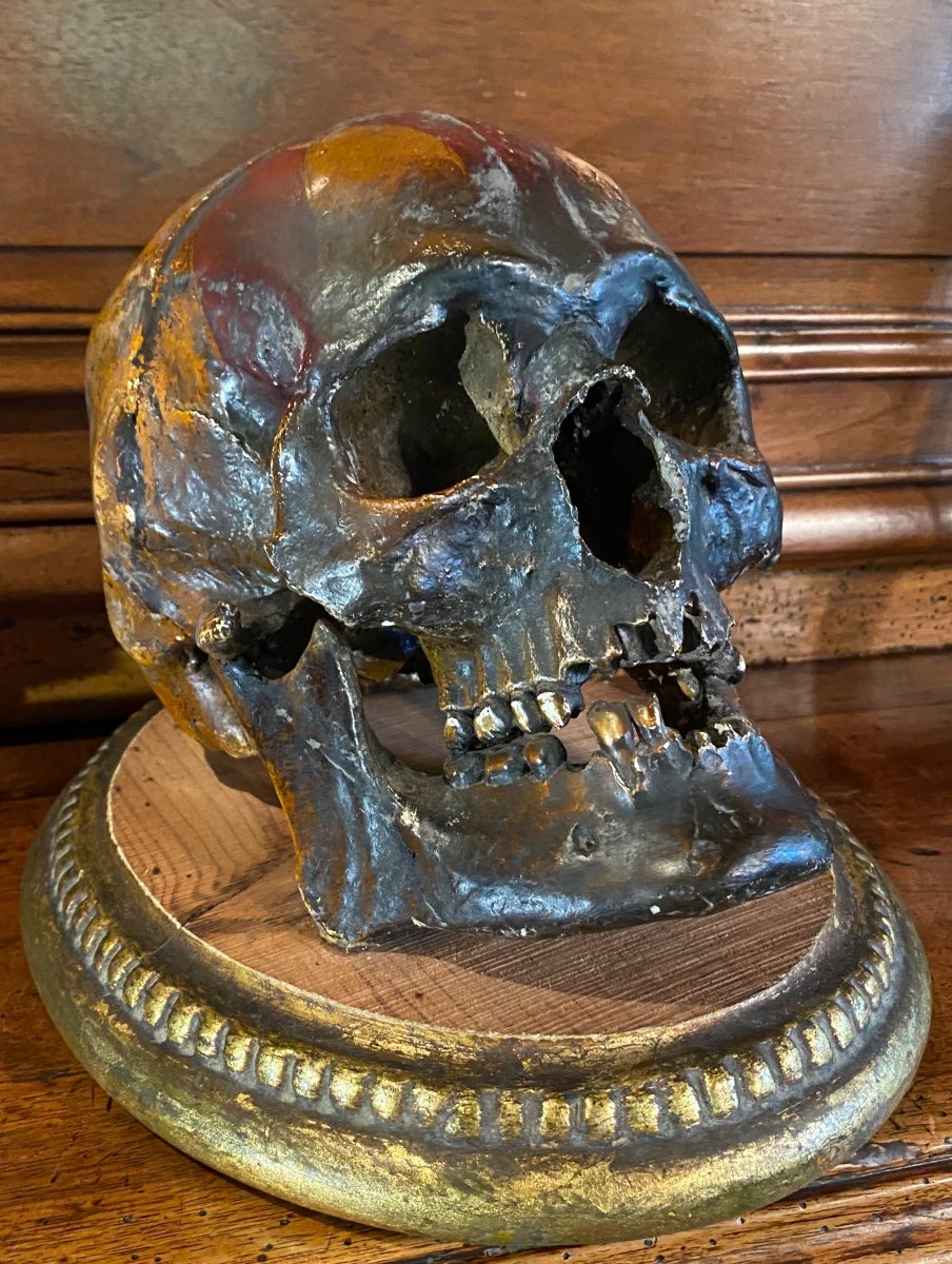 Realistic Skull In Tribal Painted Terracotta, On A Golden Wooden Base-photo-2