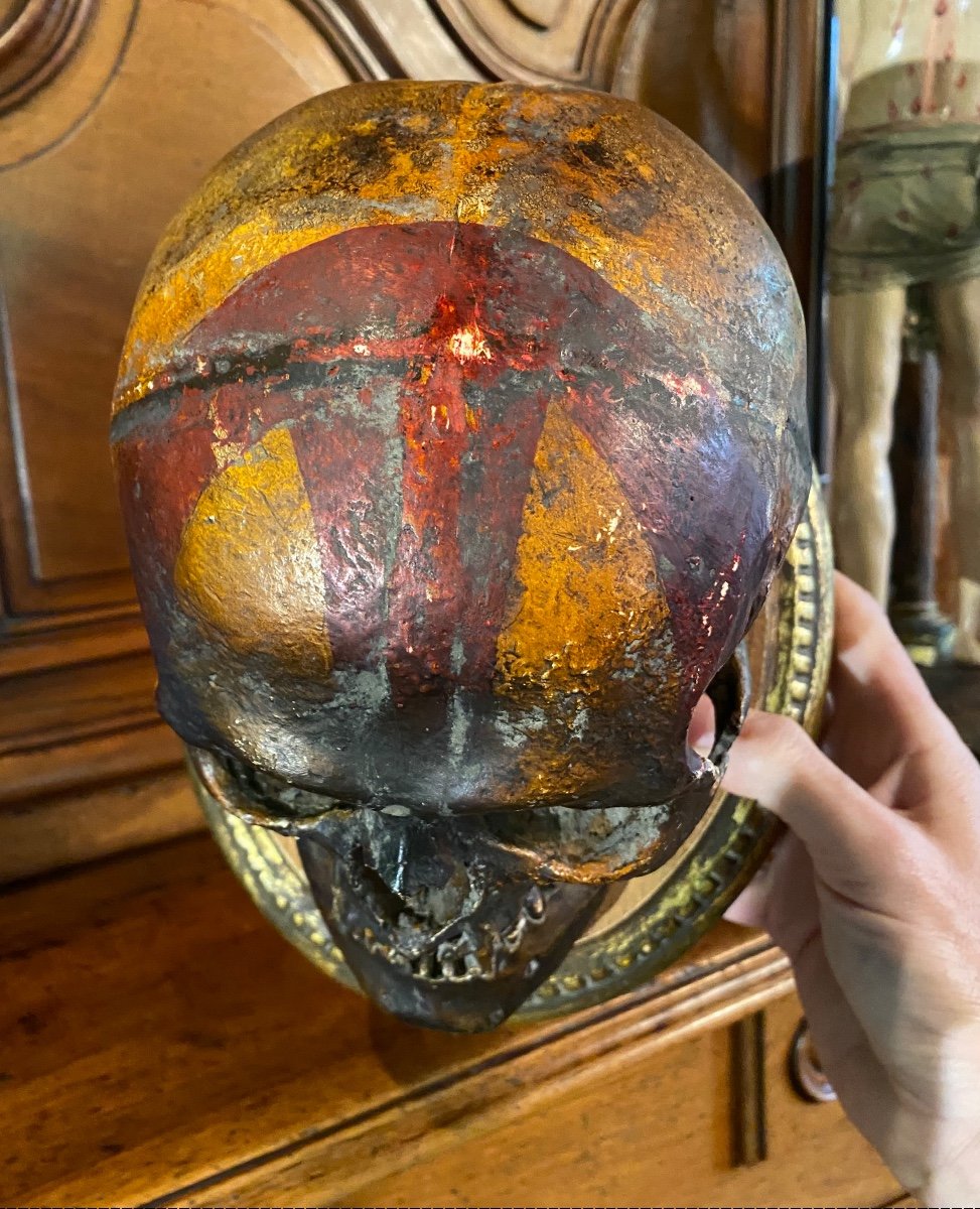 Realistic Skull In Tribal Painted Terracotta, On A Golden Wooden Base-photo-1