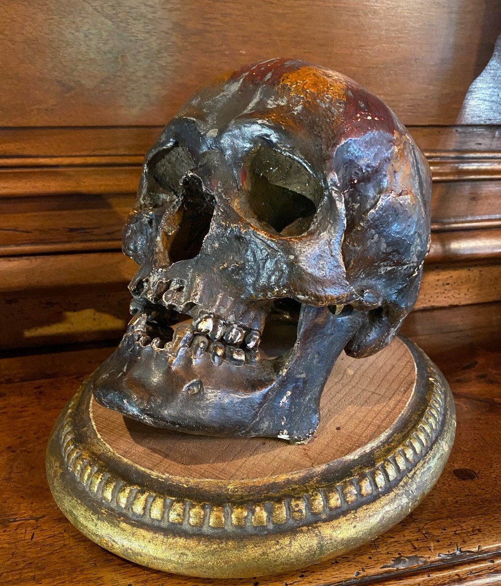 Realistic Skull In Tribal Painted Terracotta, On A Golden Wooden Base