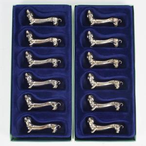 Suite Of 12 Knife Holders In Silver Metal, In The Shape Of A Dog, 1980.