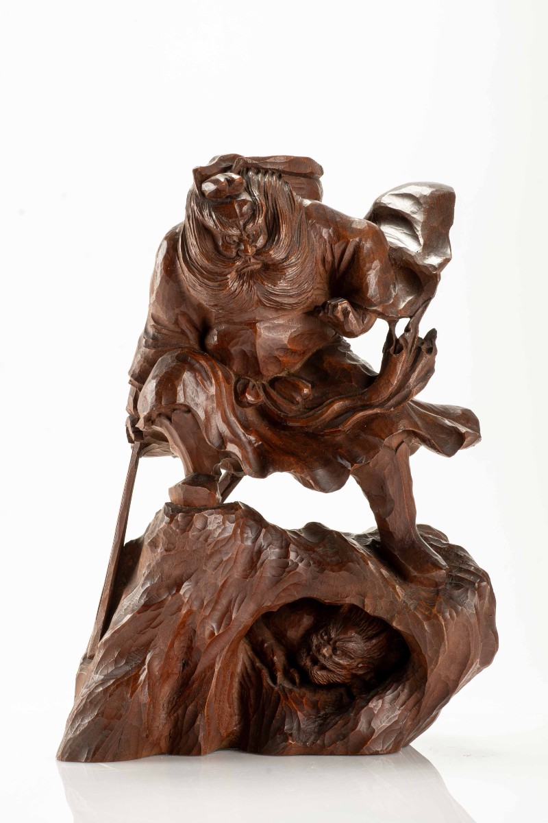 A Boxwood Okimono Depicting Shōki Attempting To Surprise An Oni