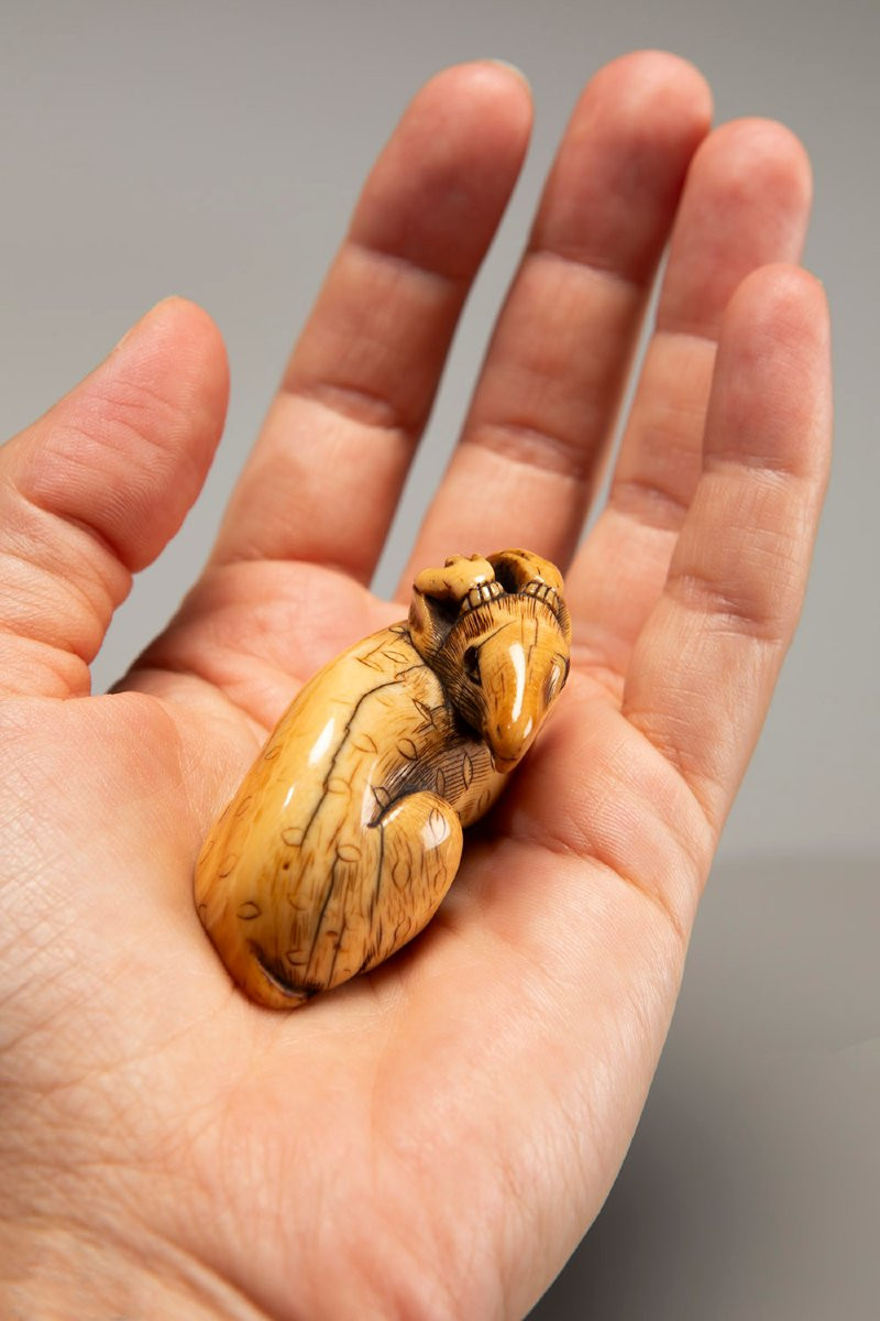 An Ivory Netsuke Depicting A Crouching Deer-photo-2