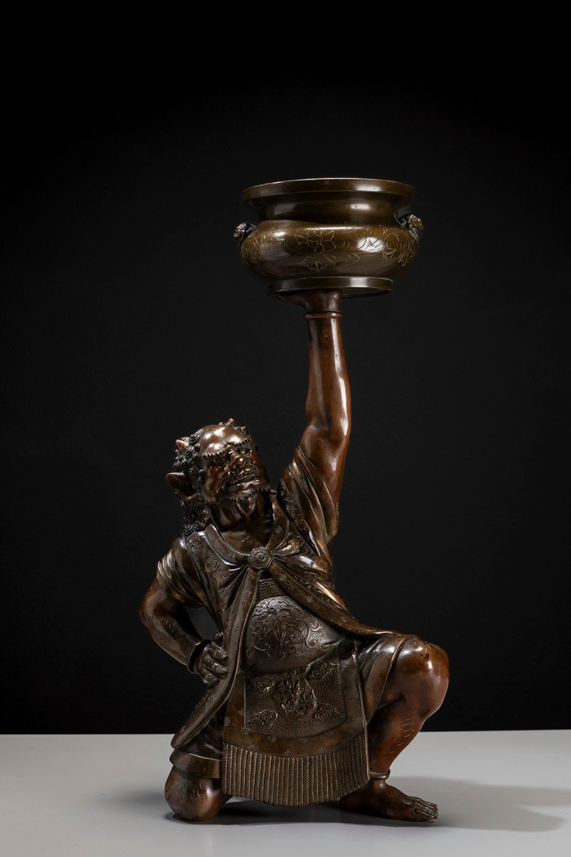 A Japanese Bronze Sculpture Depicting An Oni With A Ceremonial Koro
