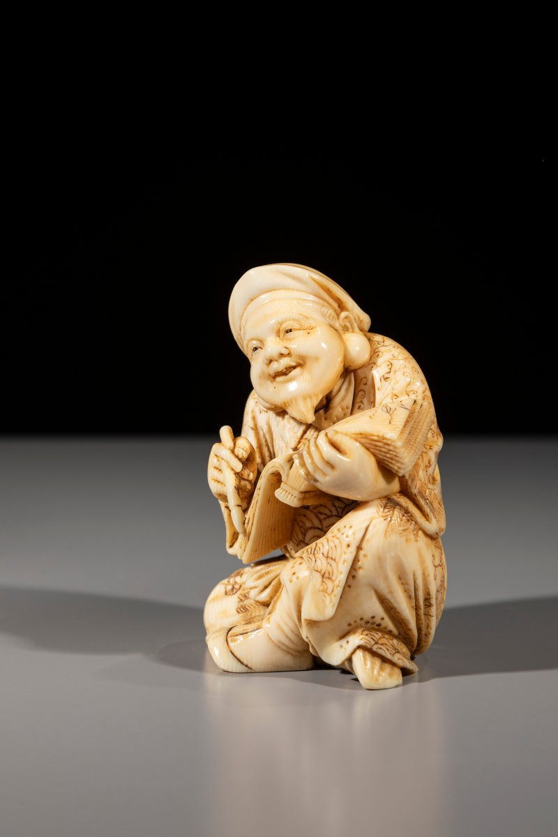 An Ivory Okimono Of Daikoku With Brush And Book-photo-2