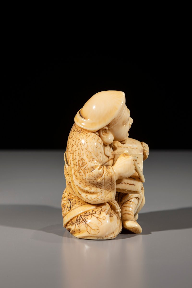 An Ivory Okimono Of Daikoku With Brush And Book-photo-1