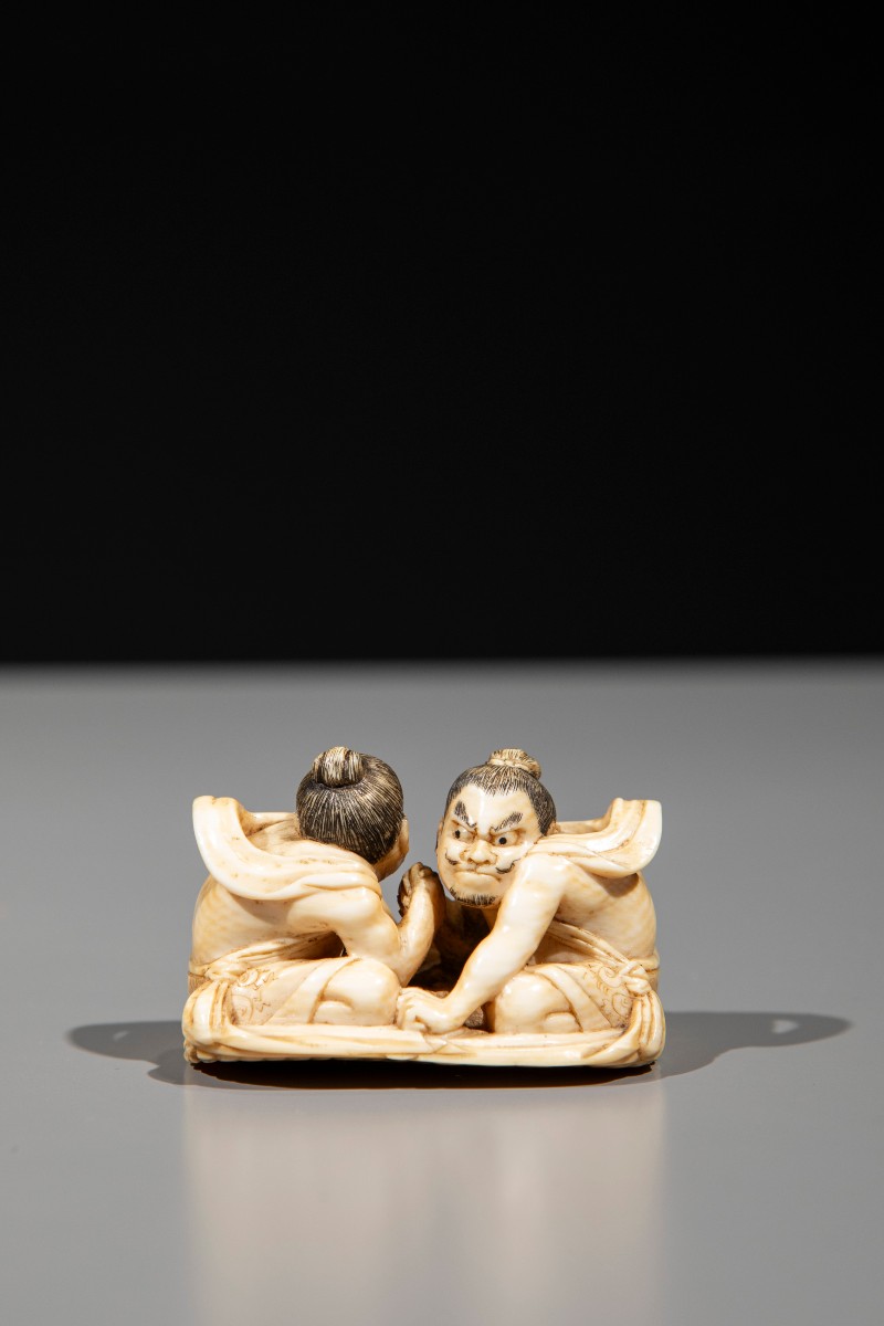 An Ivory Netsuke Depicting Raijin And Fujin On A Sandal