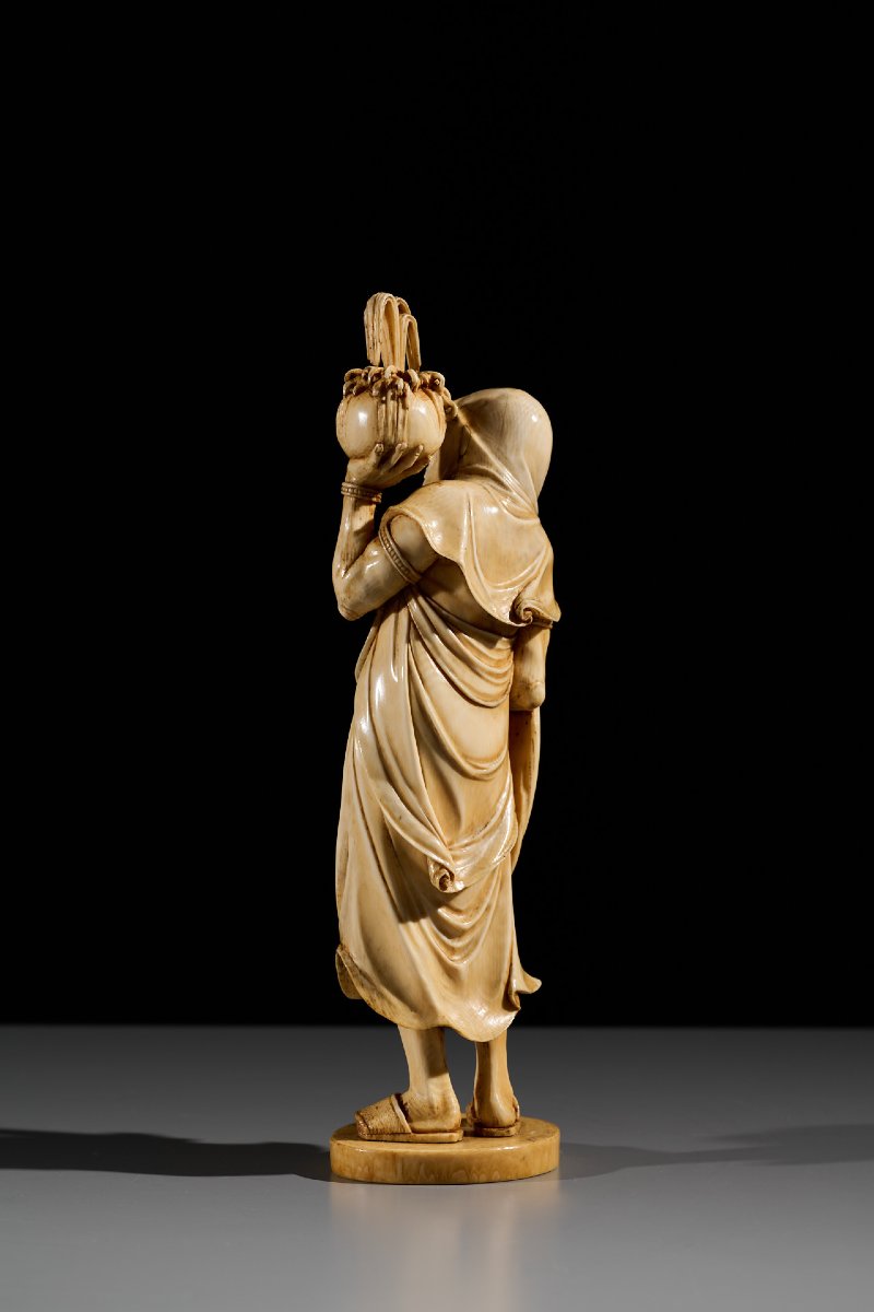 An Ivory Okimono Of A Rakan Holding A Ritual Vase, Signed Kazutoshi-photo-2