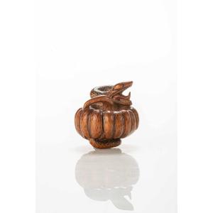 A Boxwood Netsuke Depicting A Snake Wrapping Around A Pumpkin