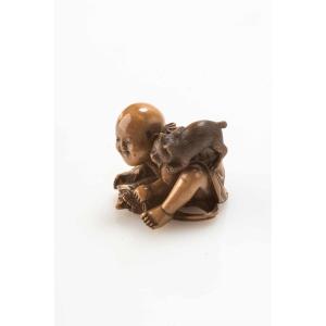 A Japanese Ivory Netsuke Depicting A Child With A Turtle And A Cat