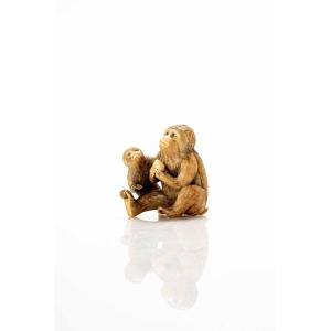 An Ivory Netsuke Depicting A Pair Of Sitting Monkeys