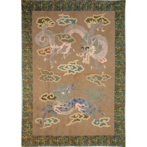 A Silk Tapestry With Raised Embroidery Depicting A Dragon And A Kirin Among The Clouds