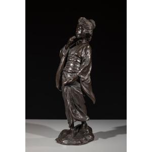 A Bronze Okimono Depicting A Walking Geisha, Signed Seiya Zō