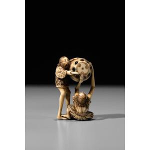 An Ivory Okimono Depicting Ashinaga And Tenaga With A Drum, Signed Hidemasa