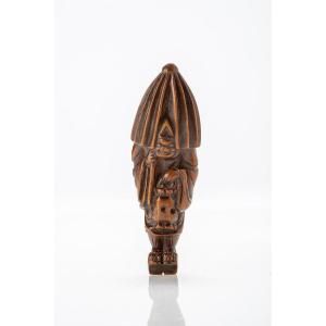 A Japanese Netsuke Of A Priest With Umbrella And Lantern