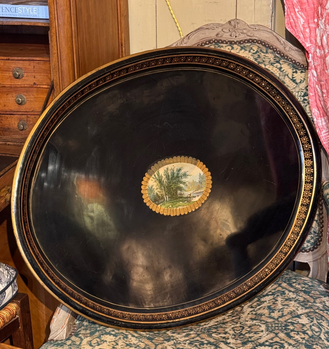 Oval Tray In Black And Gold Lacquered Metal, Decorated With A Chromolithographed Landscape