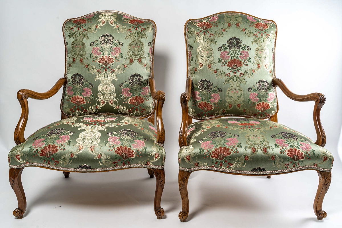 Paire de larges et bas fauteuils en noyer mouluré et sculpté, époque Régence vers 1720