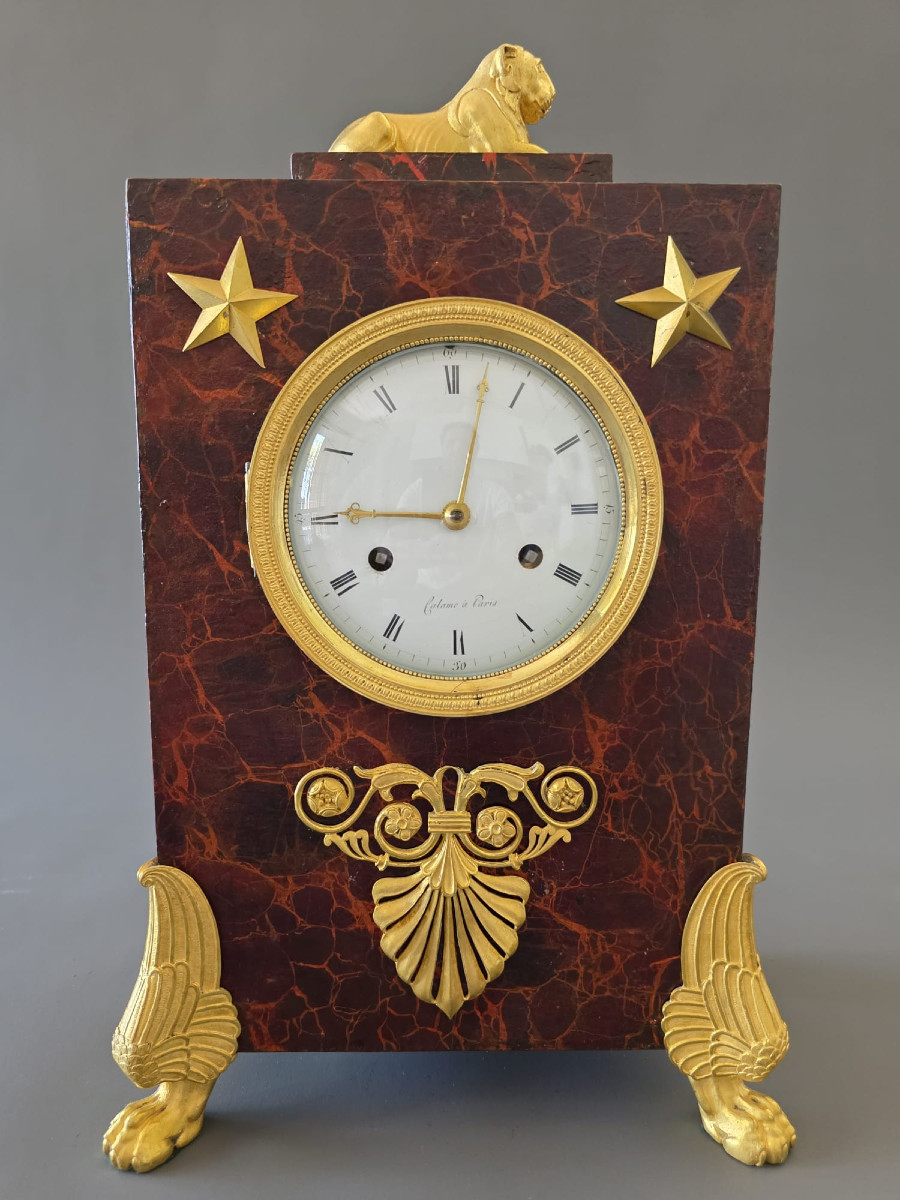  Pendule borne en tôle peinte et bronze doré, d’époque Empire.