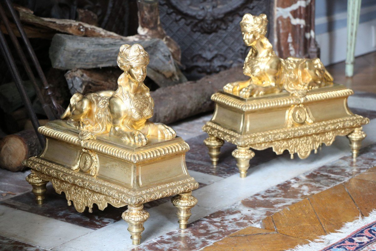 Pair Of Andirons In Gilt And Chiseled Bronze Adorned With Imposing Sphinxes
