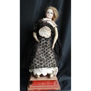 Porcelain Head Doll With Closed Mouth And Skin Body