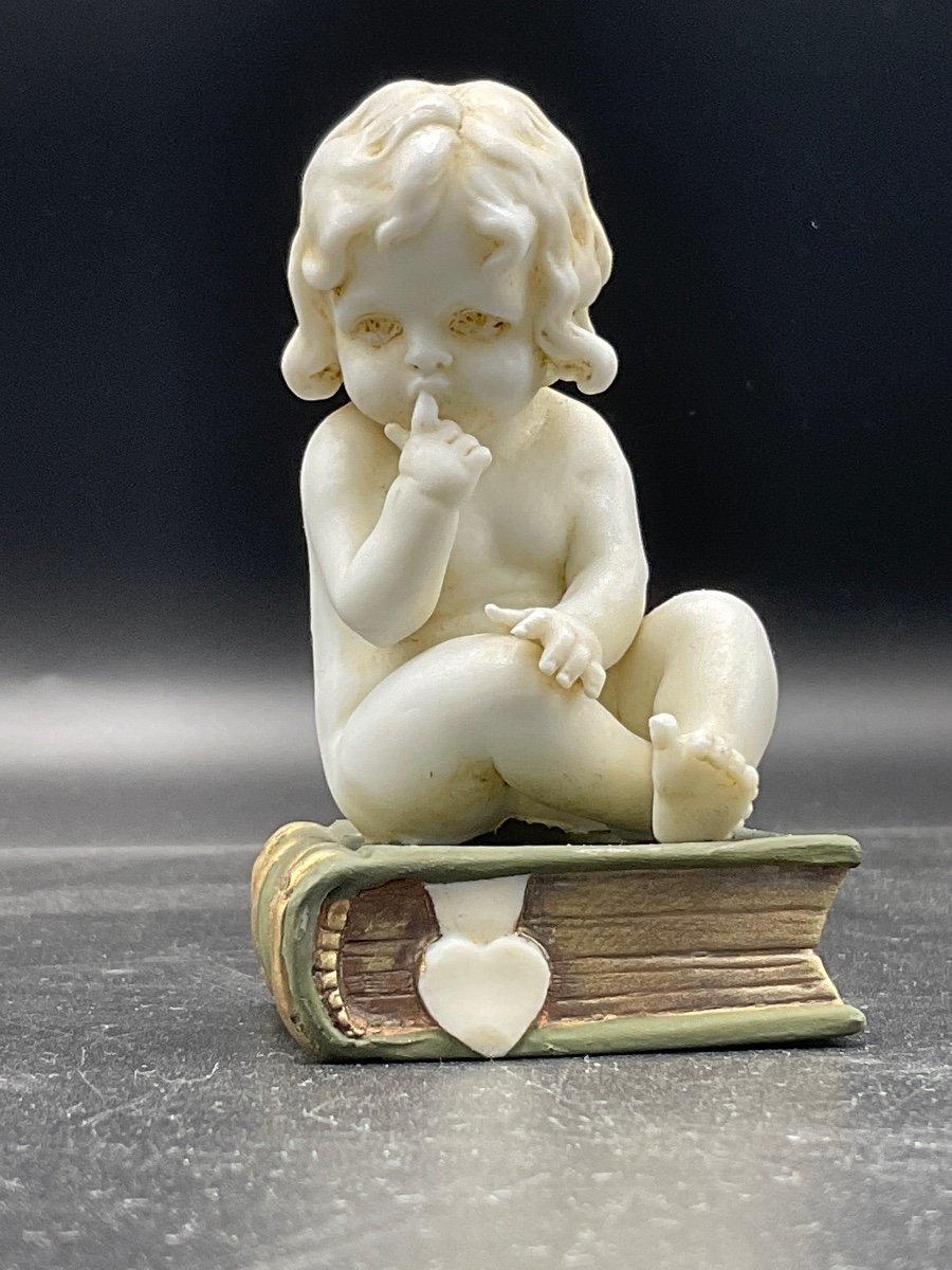 Biscuit From The Müller Factory Representing A Little Girl Sitting On A Book.-photo-2
