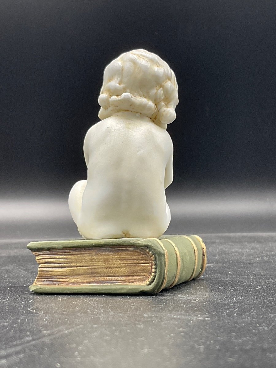 Biscuit From The Müller Factory Representing A Little Girl Sitting On A Book.-photo-3