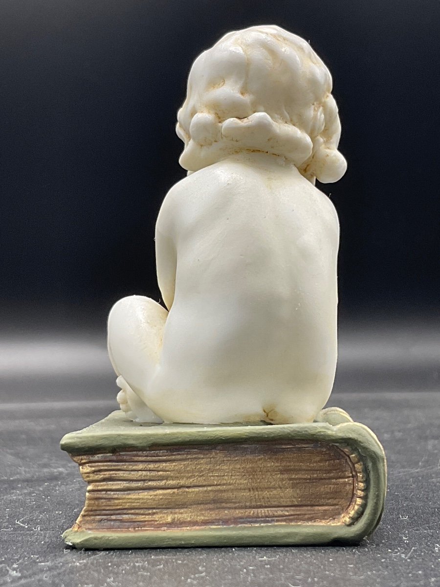 Biscuit From The Müller Factory Representing A Little Girl Sitting On A Book.-photo-5