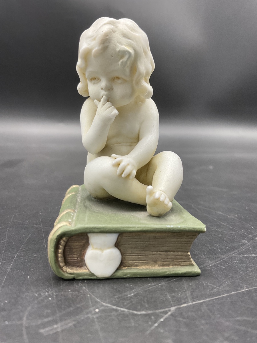 A Biscuit Attributed To La Manufacture De Müller, Depicting A Little Girl Sitting On A Book.