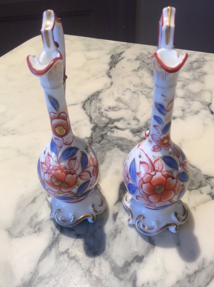 Pair Of Polychrome Bayeux Porcelain Ewers Decorated With Red And Gold Flowers And Blue, Carmine Red And Gold Foliage.