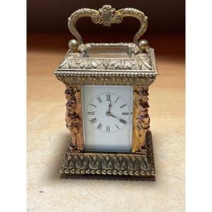 Officer Or Miniature Travel Clock With Caryatids In Golden Chiseled Bronze.