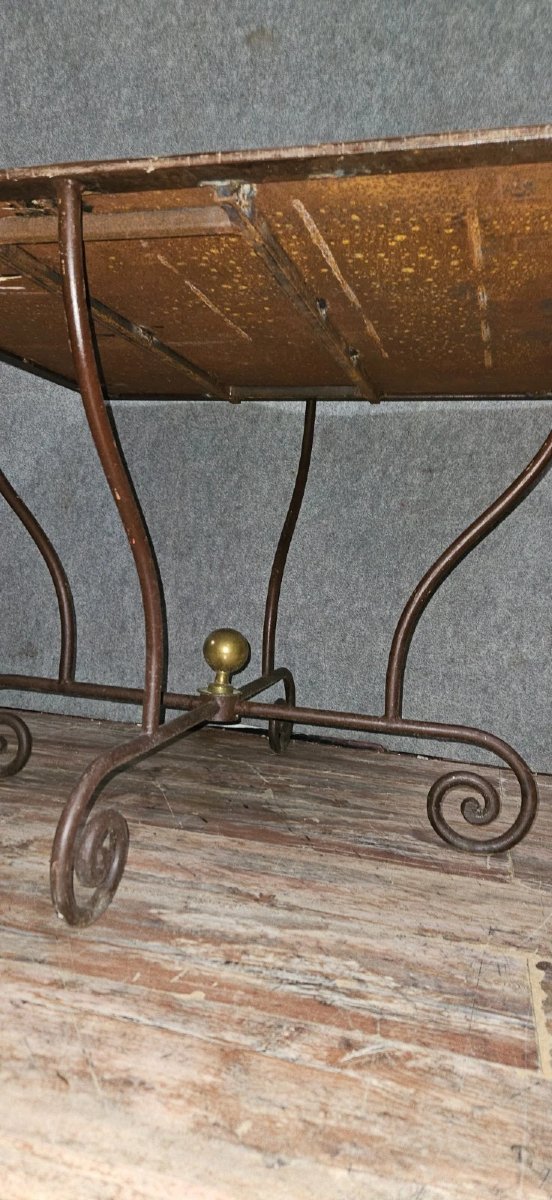Wrought Iron Table With Sculptural Base, Adorned With Scrolls And A Central Brass Element. -photo-5