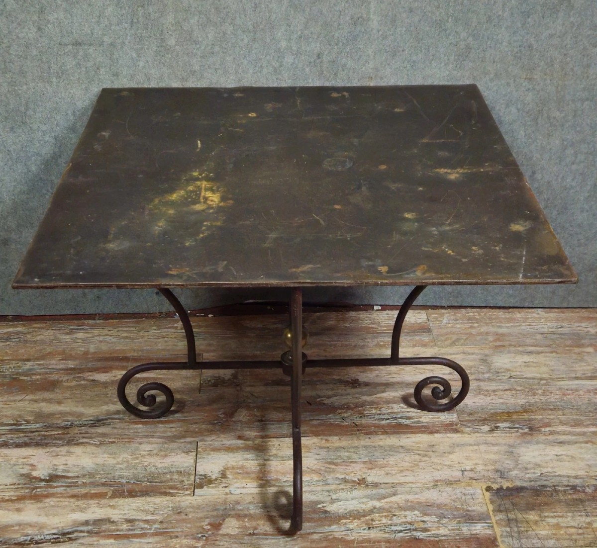 Wrought Iron Table With Sculptural Base, Adorned With Scrolls And A Central Brass Element. 