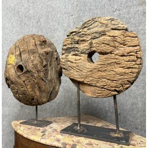 Two Very Old Wooden Pulley Wheels Mounted On Iron Bases  