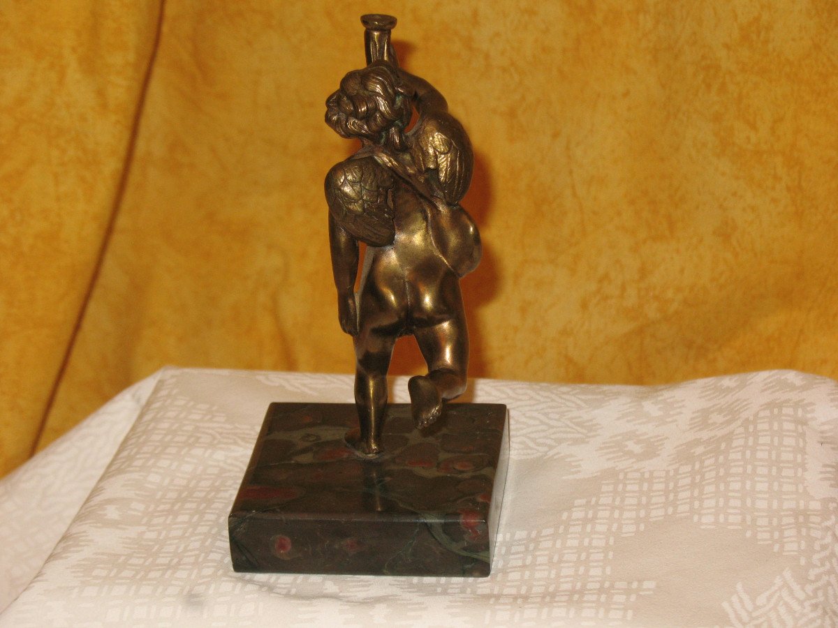 Bronze Sculpture Of A Cherub Carrying A Torch-photo-1