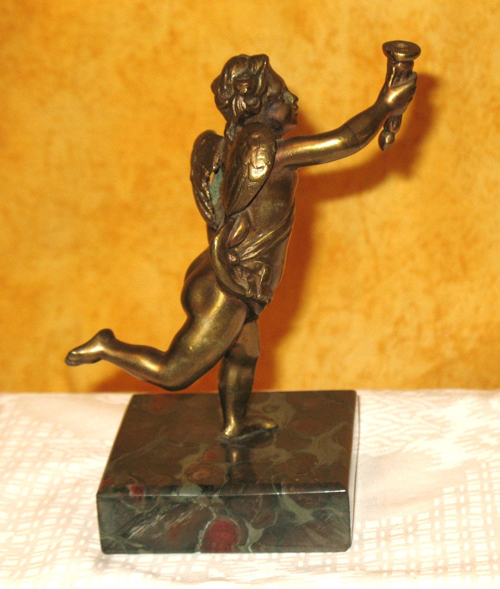 Bronze Sculpture Of A Cherub Carrying A Torch