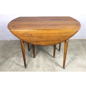 Table ronde à volets 6 pieds en noyer blond massif et ses 2 allonges style Louis XVI ép. 19ème