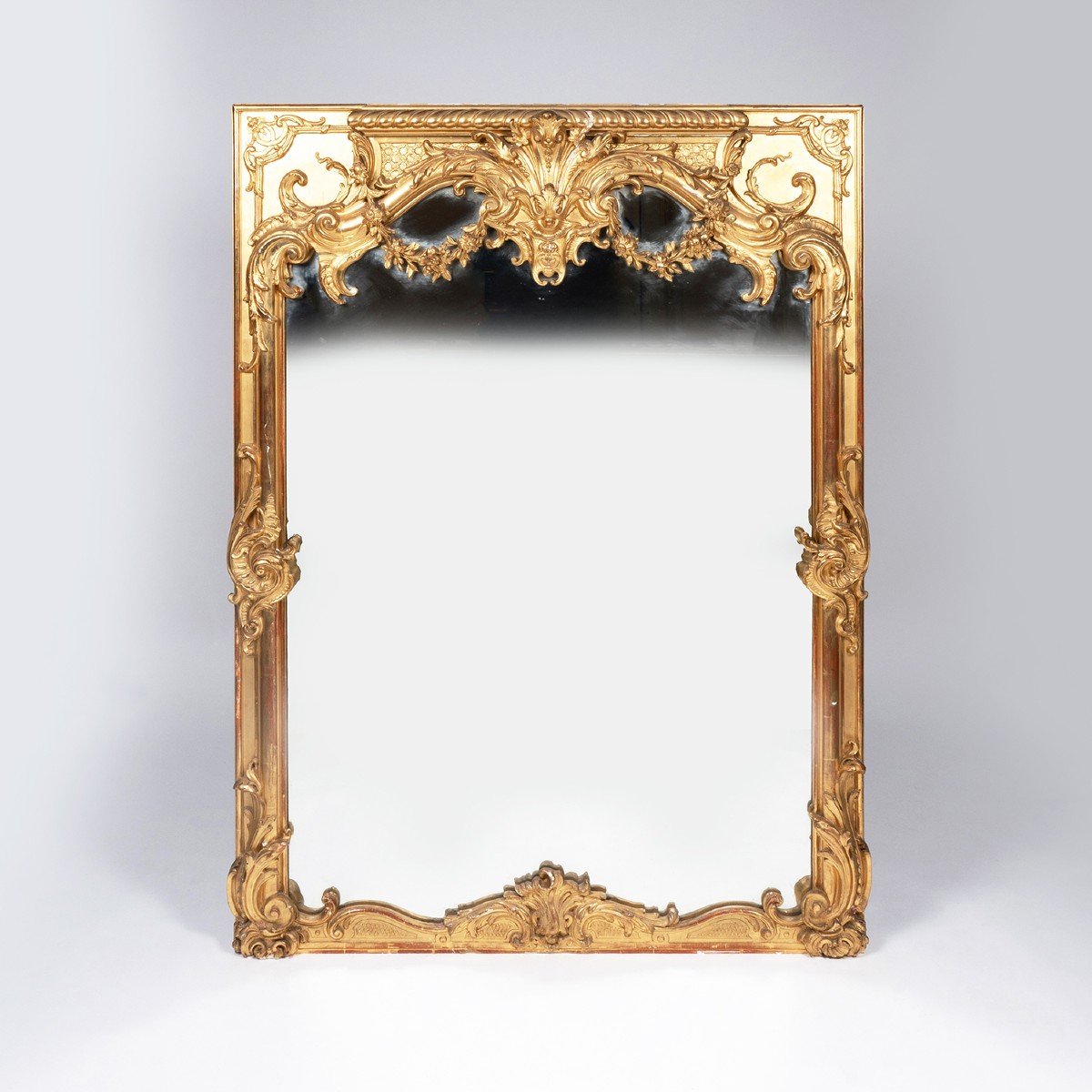 Important miroir trumeau en bois stuqué et doré de style Régence, XIXe