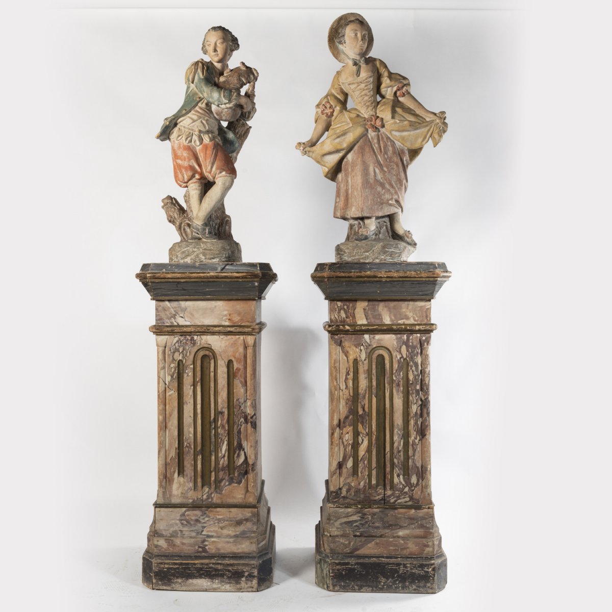 Paire de sculptures en terre cuite sur deux colonnes en bois peint en trompe-l'oeil, XIXe