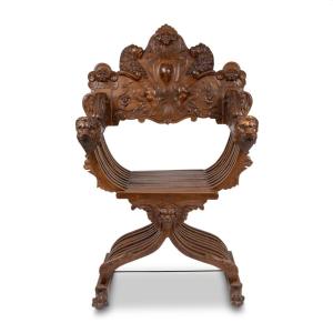 Fauteuil curule dit Dagobert en noyer sculpté à décor de lions, XIXe