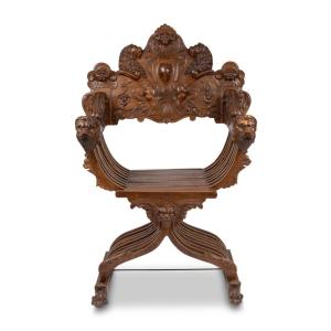 Fauteuil curule dit Dagobert en noyer sculpt&eacute; &agrave; d&eacute;cor de lions, XIXe