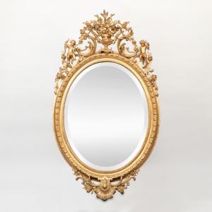 Oval Mirror In Wood And Gilded Stucco With A Pediment Of Putti, 19th
