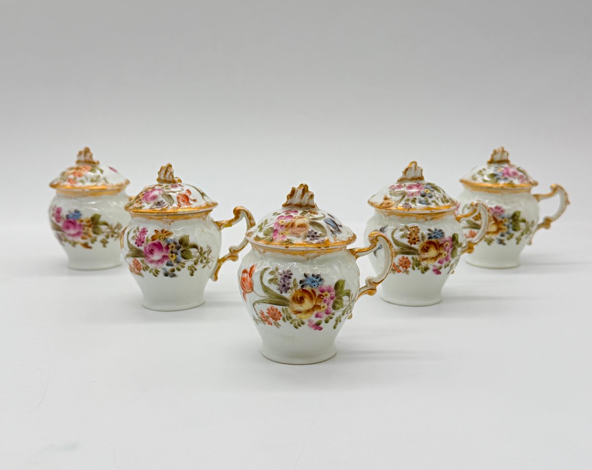 SUITE DE CINQ POTS À CRÈME EN PORCELAINE DE LIMOGES À DÉCOR FLORAL POLYCHROME ET DORURE