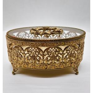 Coffret ovale en verre, de fabrication française, doté d’une monture en laiton ajouré