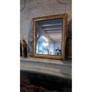 Miroir en bois doré fin 18e début 19e
