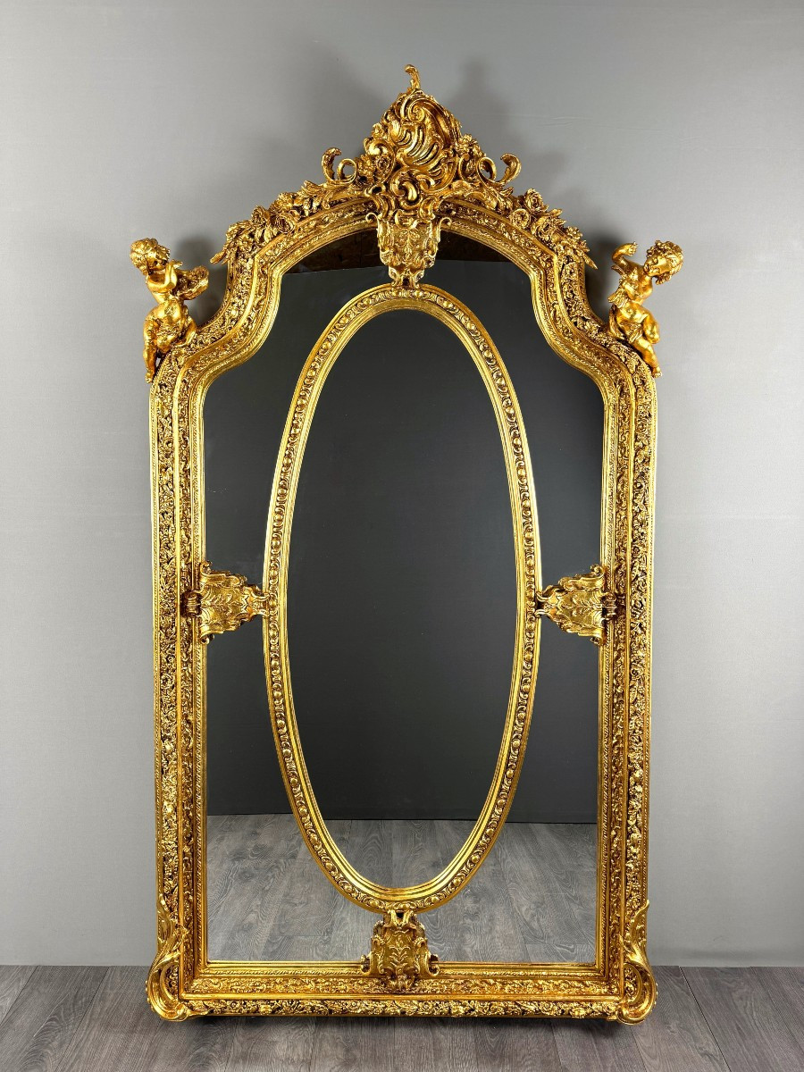 Grand miroir style Louis XV en bois sculpté et doré, XIXe siècle
