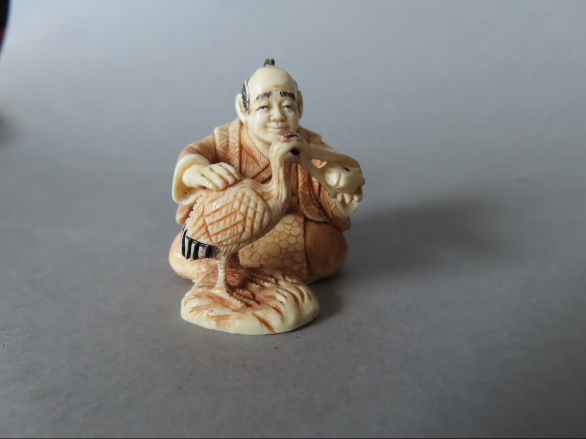 Netsuke Made Of Marine Ivory. A Crane Having Lunch. Japan, Taisho Period (1912–1928)