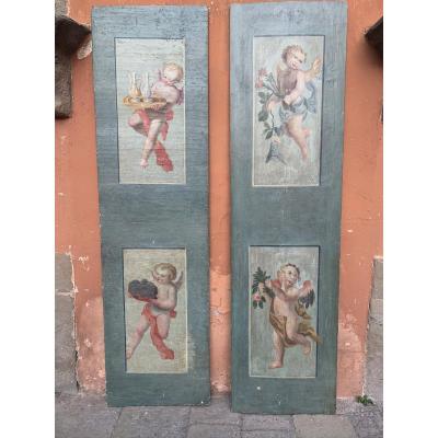 Two Panels Painted With Four Putti. 