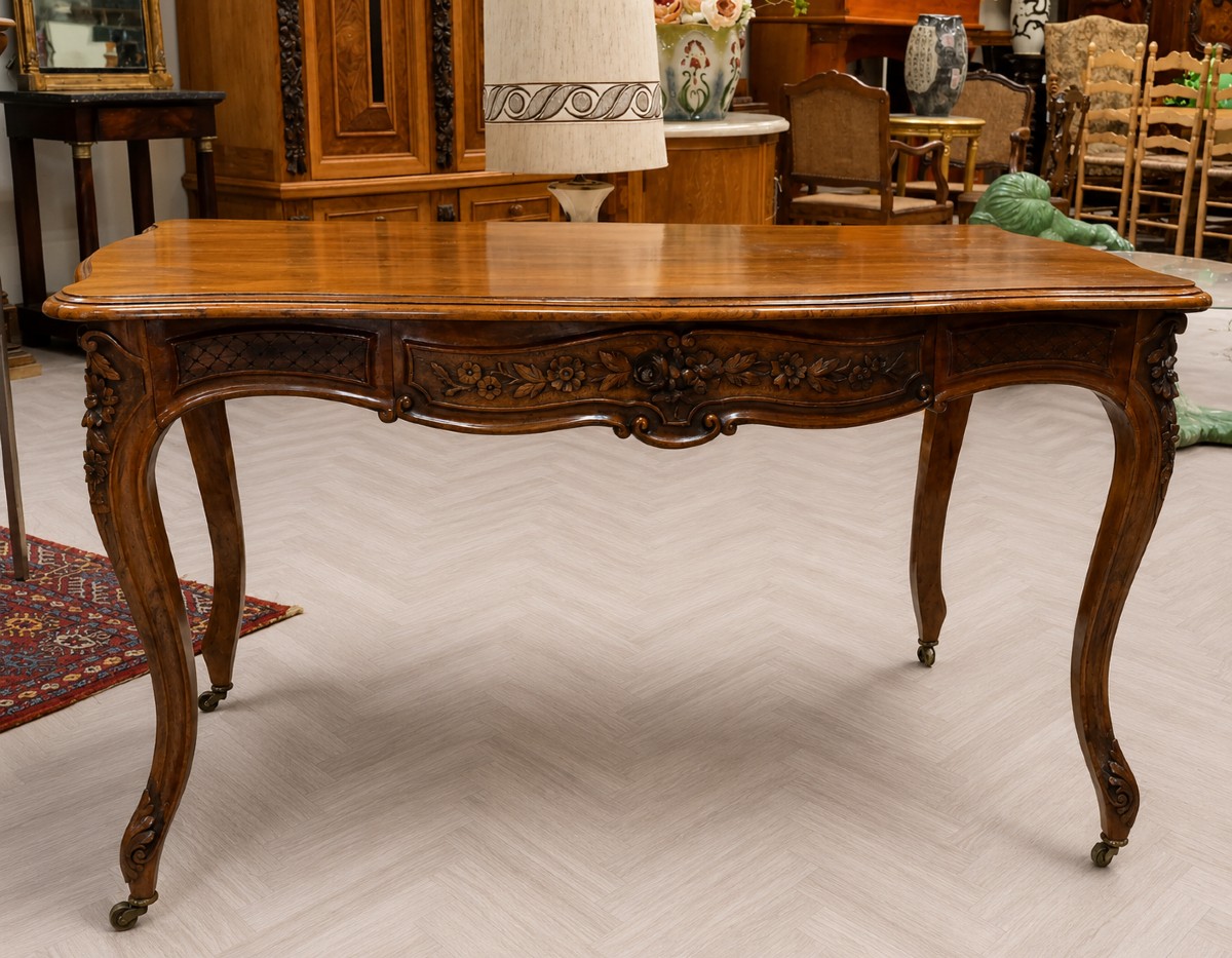 Bureau galbé de style Louis XV, en noyer sculpté et mouluré